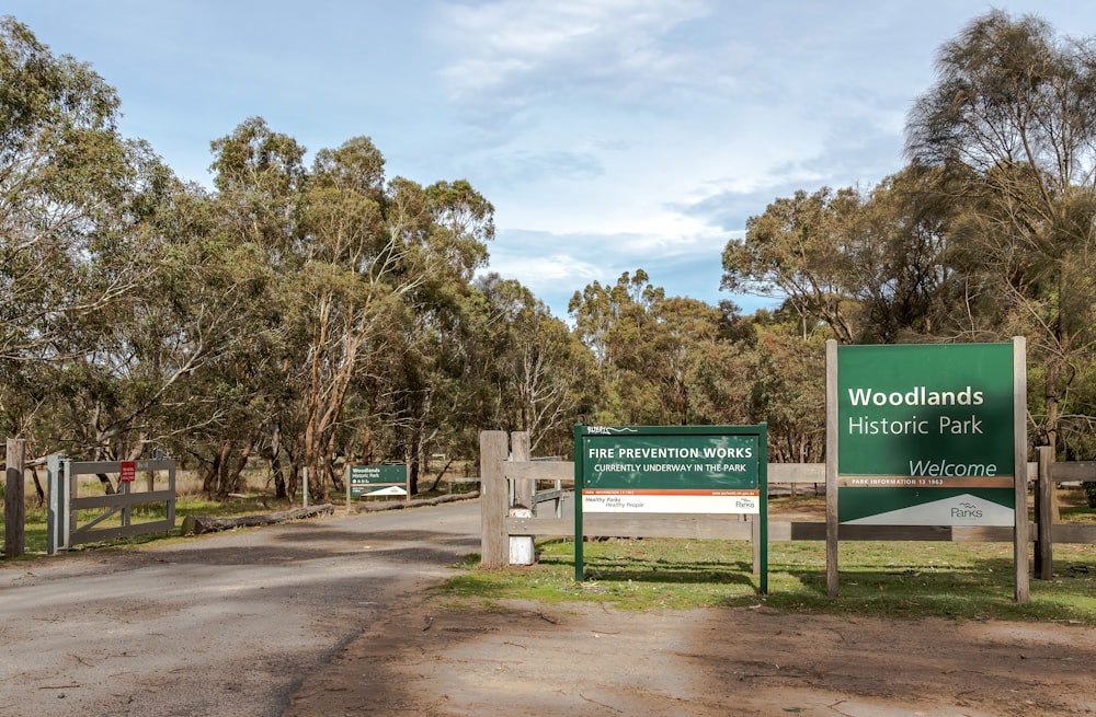 a sign for woodlandss historic park on a dirt road