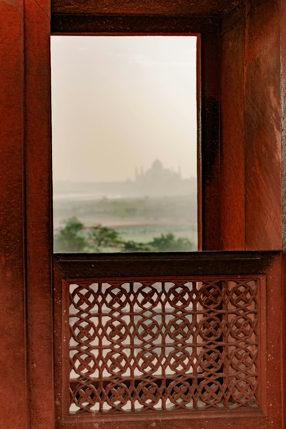 a window with a view of a castle in the distance