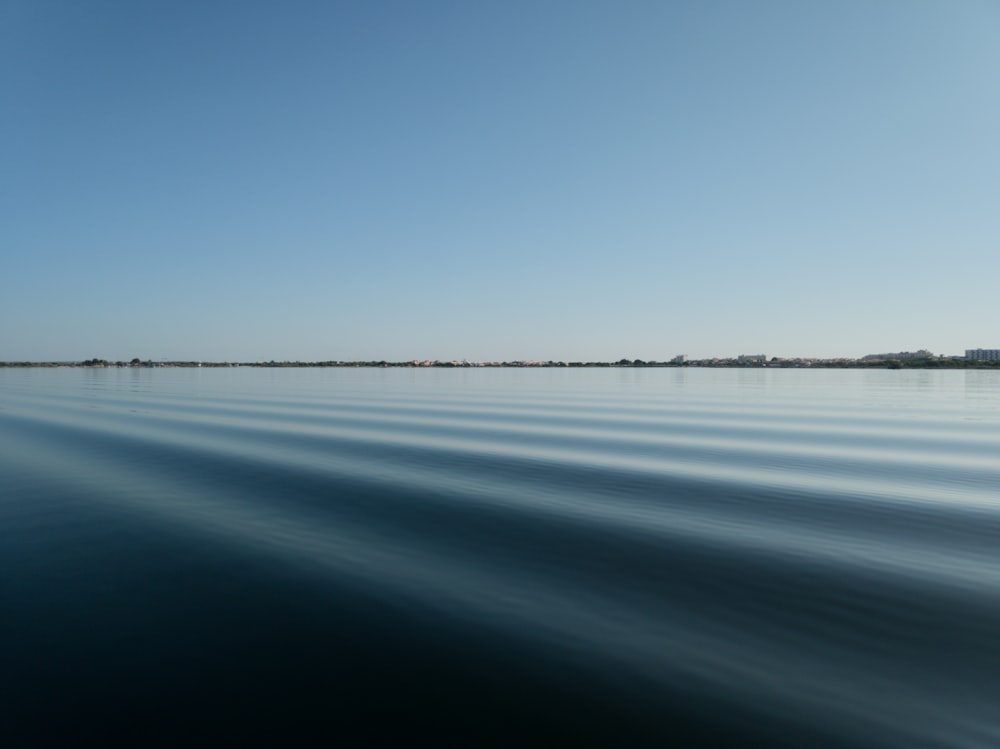 a body of water with a sky in the background