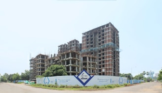 a building under construction with a sign in front of it