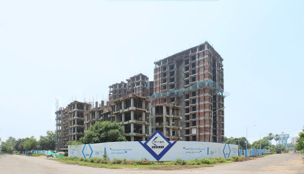 a building under construction with a sign in front of it