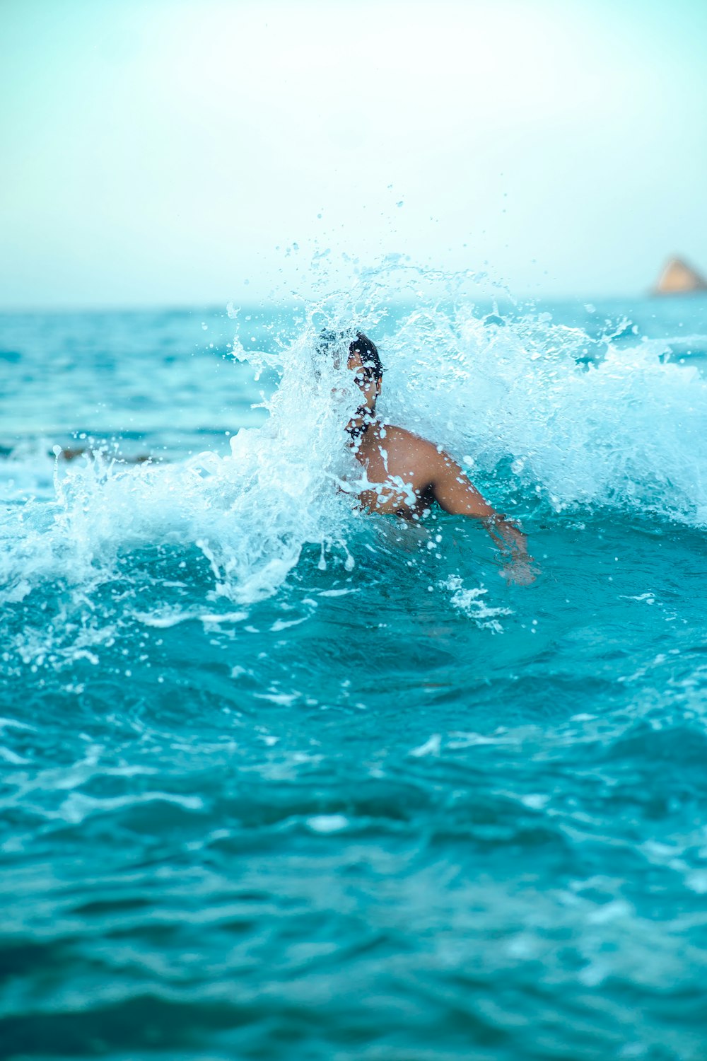 a man riding a wave on top of a surfboard