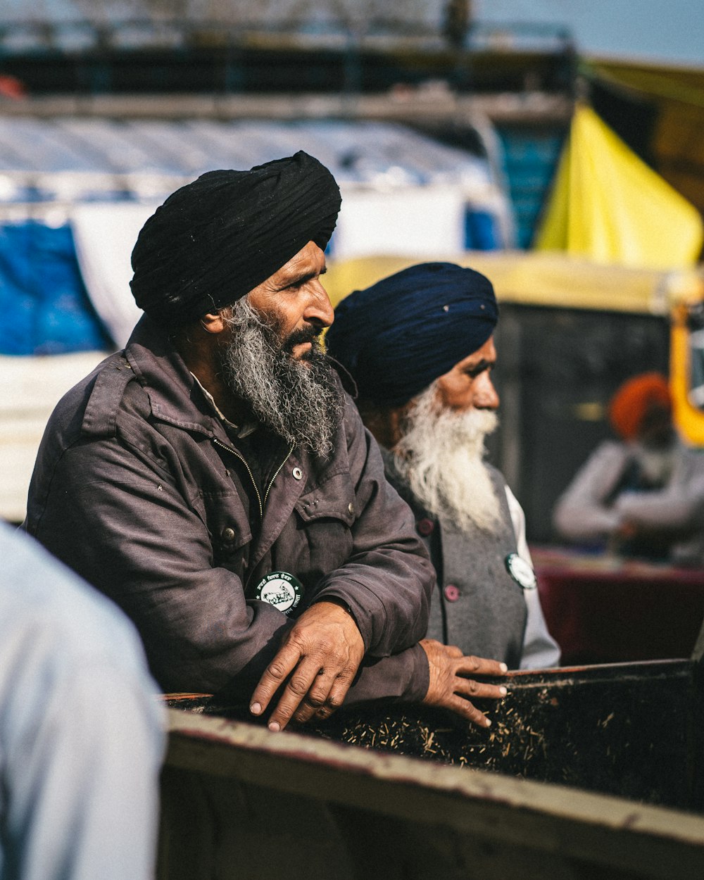 a couple of men sitting next to each other