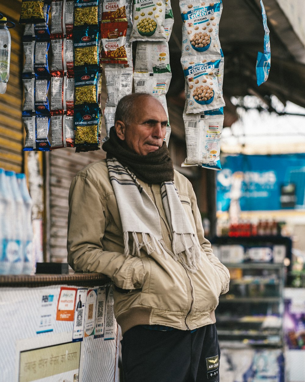 a man standing in front of a food stand