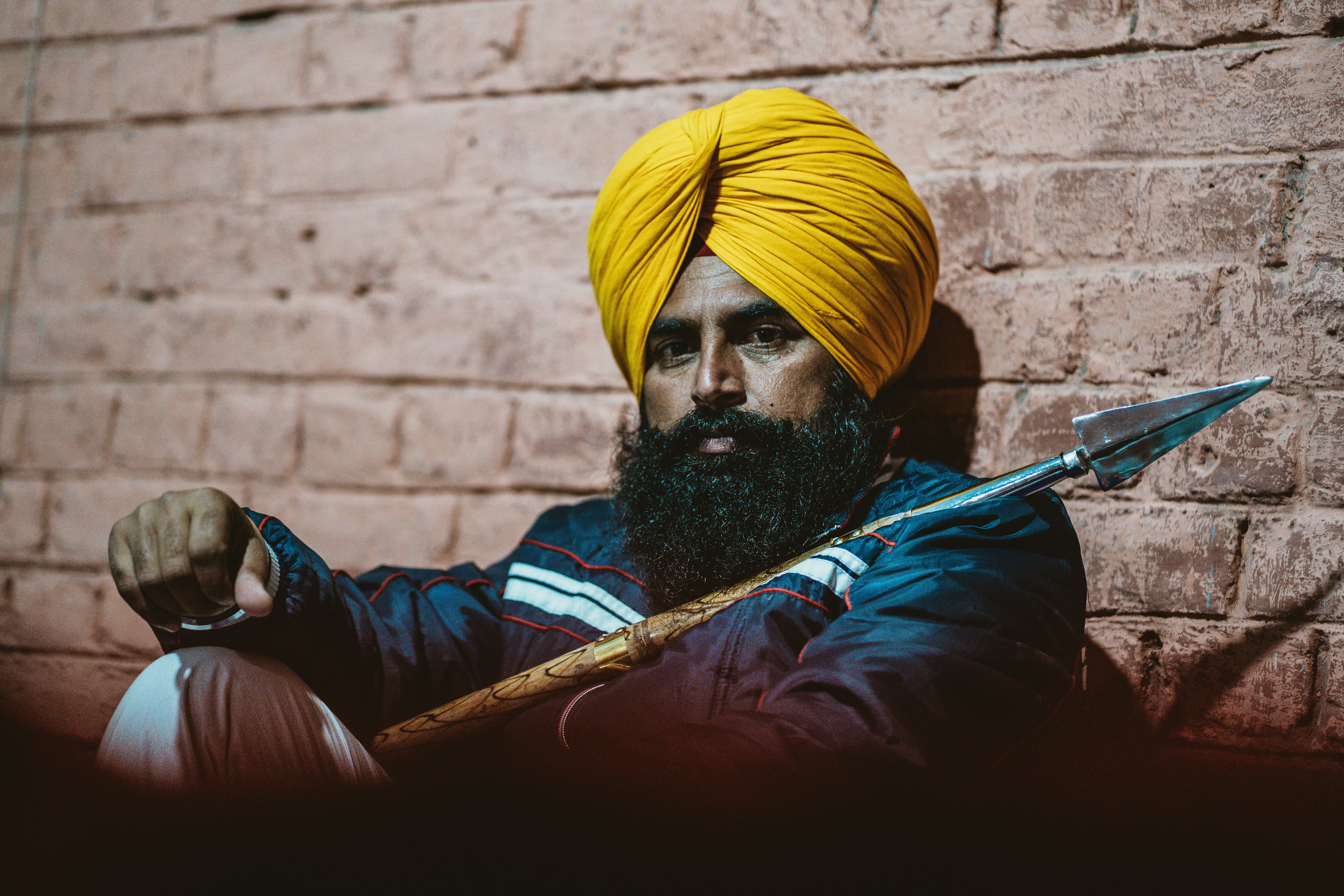 a man with a yellow turban holding a knife