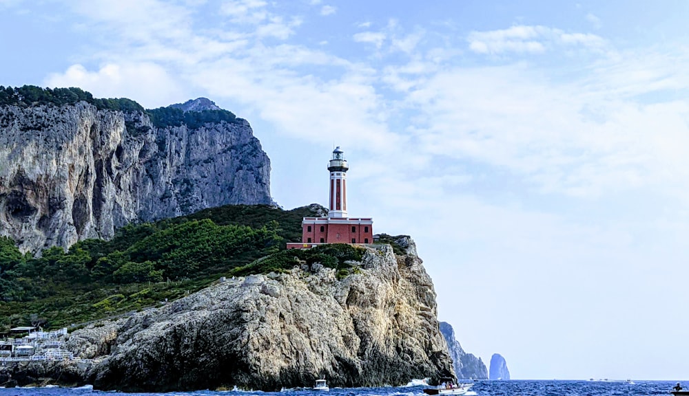 a lighthouse on top of a rock in the ocean