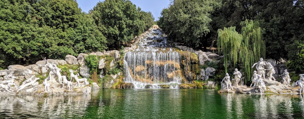 a pond with a waterfall in the middle of it