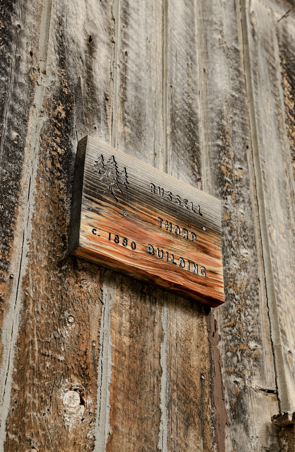 a wooden sign on the side of a building