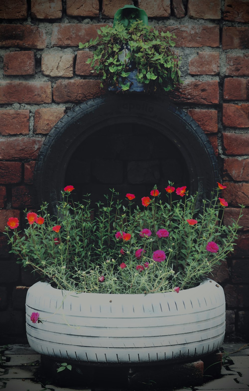 a planter filled with flowers sitting on top of a brick wall