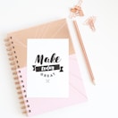 a notepad with the words make today great written on it