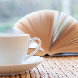 A cozy reading nook with an open book and coffee.