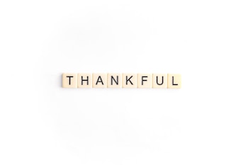 Seven tiles with black letters spelling out the word 'THANKFUL' arranged in a straight line on a white background.
