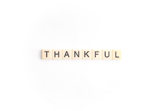 Seven tiles with black letters spelling out the word 'THANKFUL' arranged in a straight line on a white background.