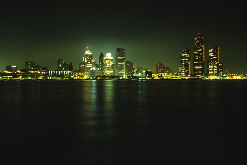 a bridge over a body of water with a city in the background