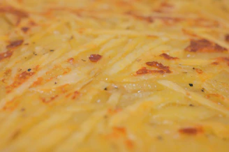 Close-up of golden crispy potato brava cuts with skin, ready to serve in a professional kitchen