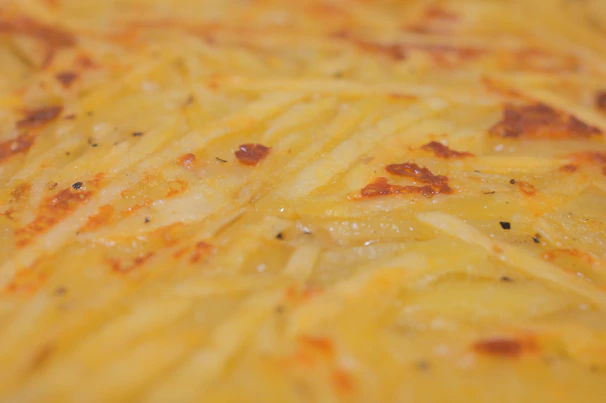 Close-up of golden crispy potato brava cuts with skin, ready to serve in a professional kitchen