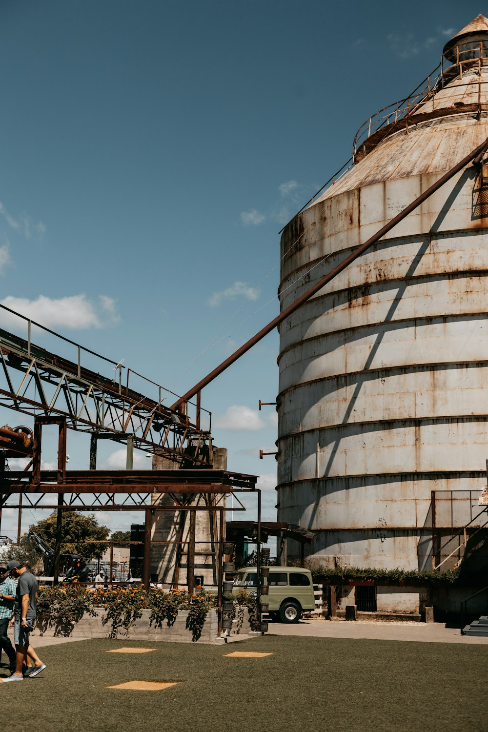 a large metal silo sitting next to a tall building