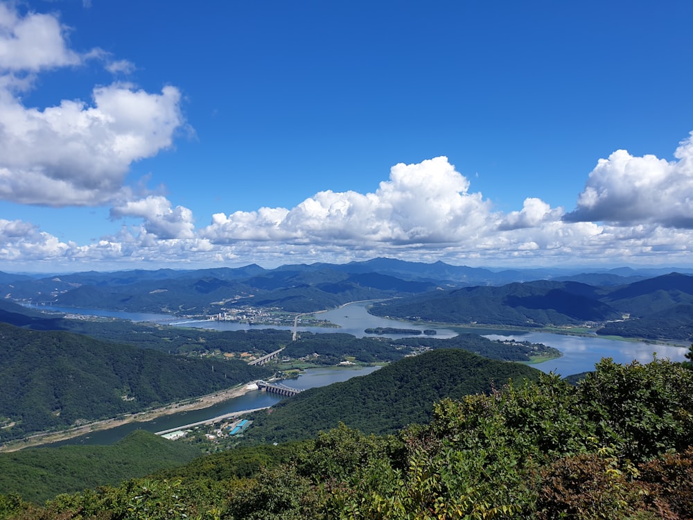 a scenic view of a river and mountains