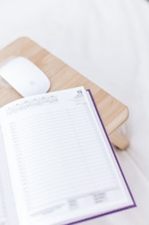 a wooden desk with a mouse and a book