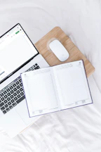 a laptop computer sitting on top of a wooden desk