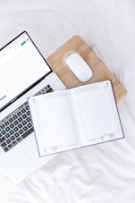 a laptop computer sitting on top of a wooden desk