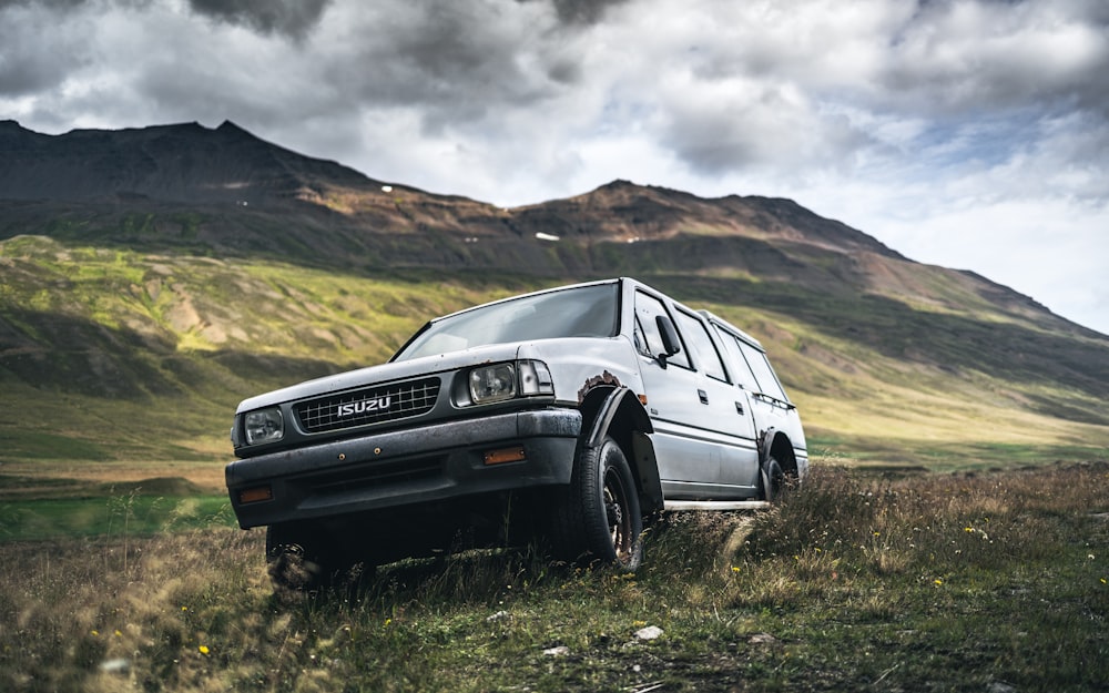 a white van is parked in a grassy field