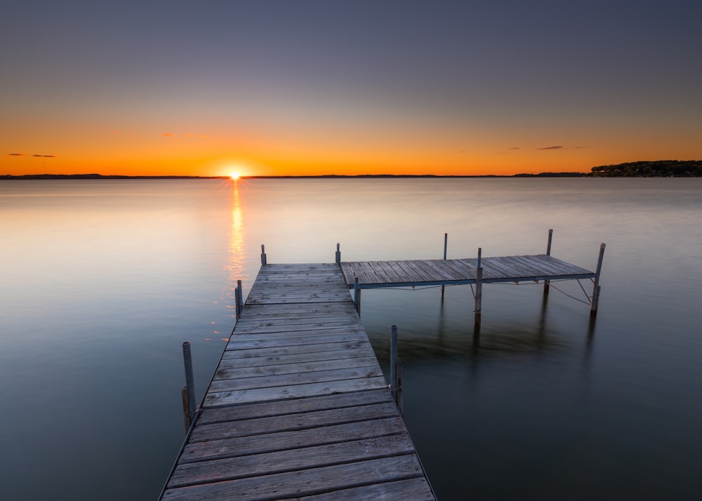 a wooden dock sitting in the middle of a body of water
