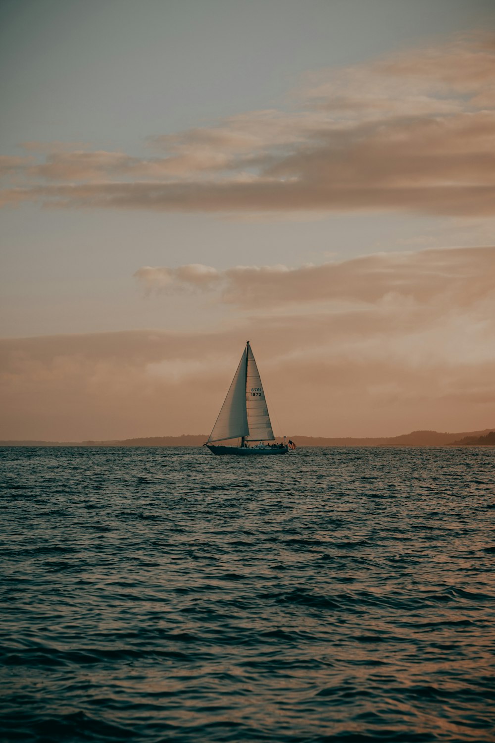 a sailboat in the middle of a body of water