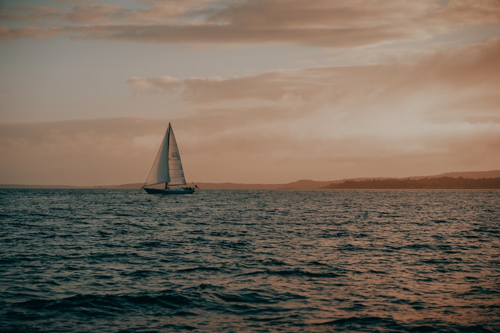 a sailboat in the middle of a body of water