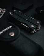 a black knife sitting on top of a black table