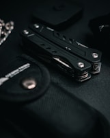 a black knife sitting on top of a black table