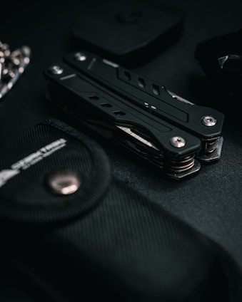 a black knife sitting on top of a black table