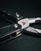 A friendly customer service representative holding a multi-functional plier, ready to assist.