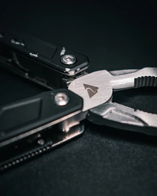 A friendly customer service representative holding a multi-functional plier, ready to assist.