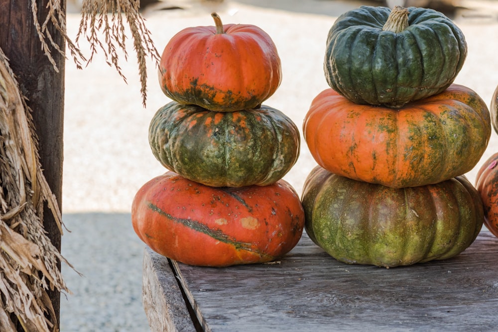 a pile of pumpkins sitting on top of a wooden table