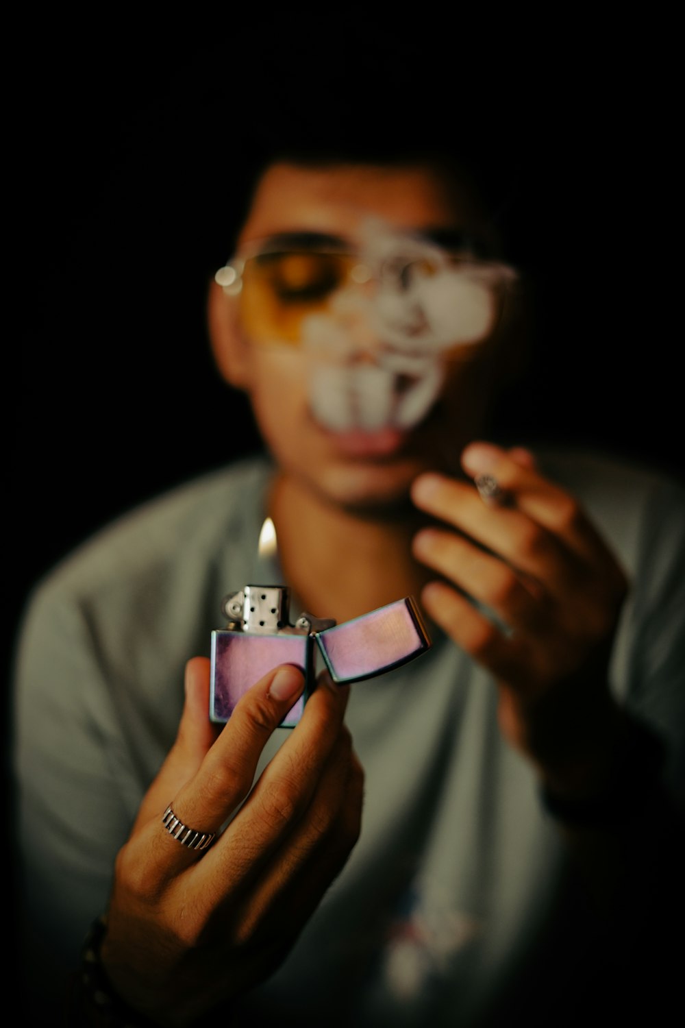 a person holding a lighter in their hand