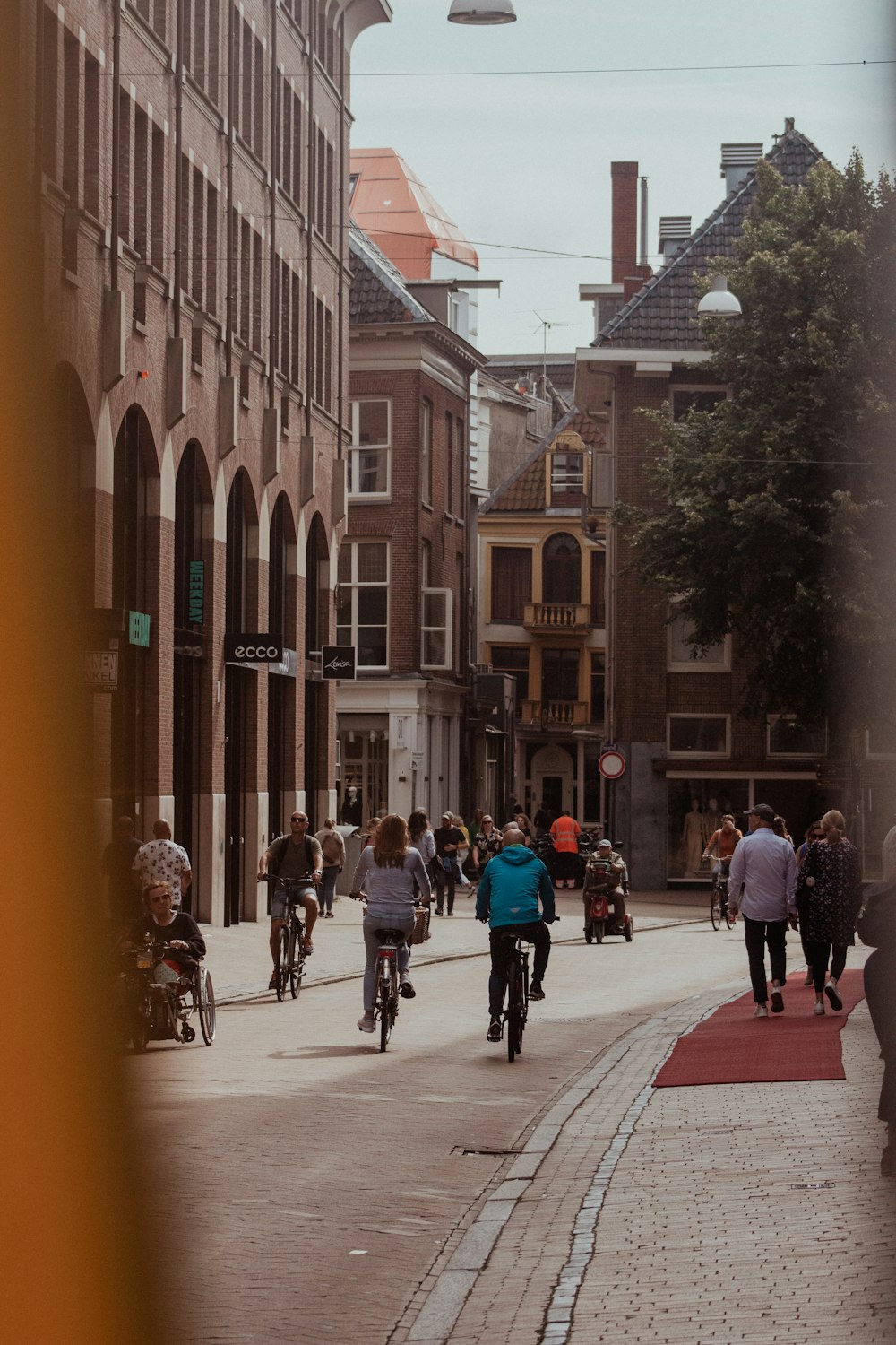 a group of people riding bikes down a street