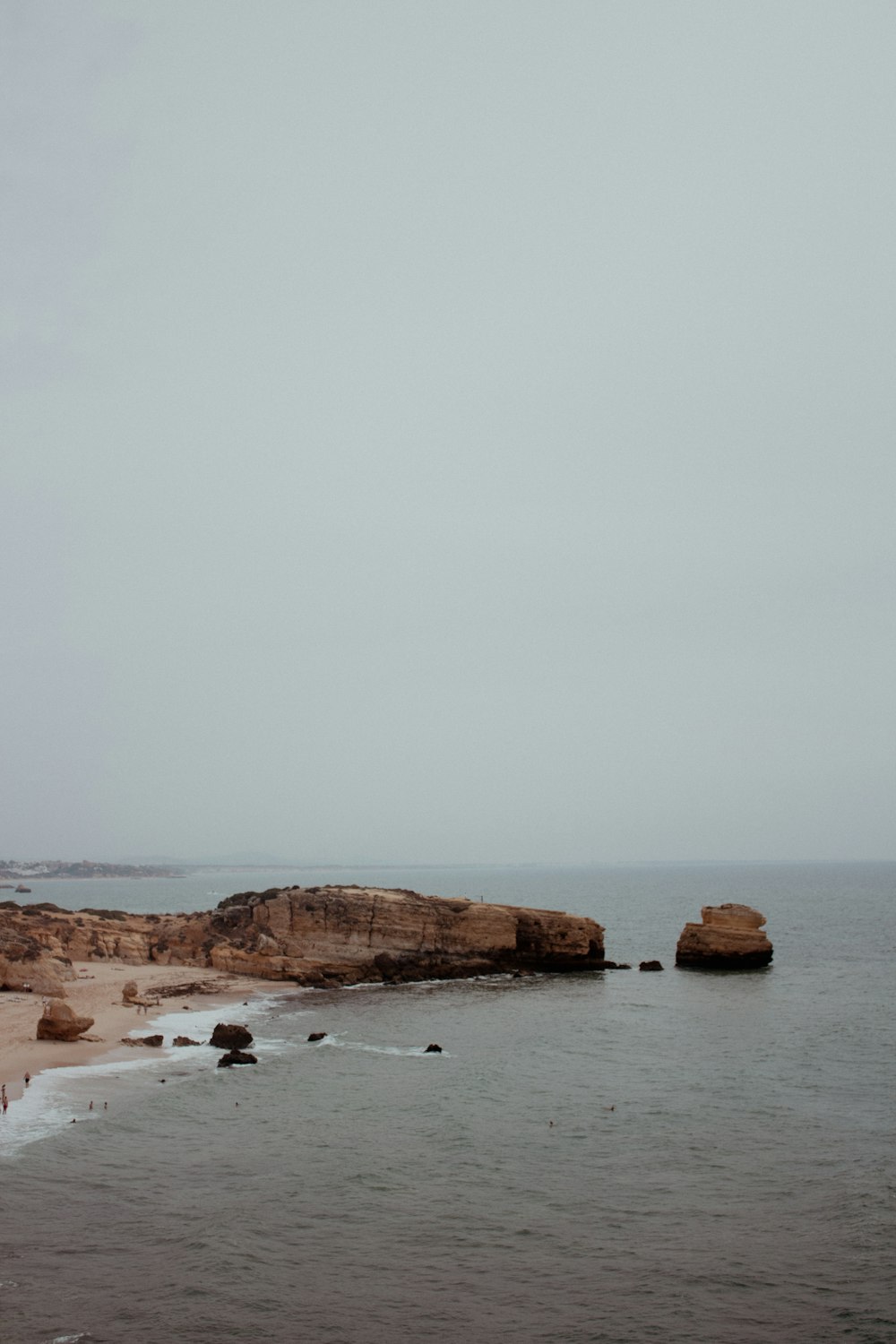 a large body of water sitting next to a sandy beach