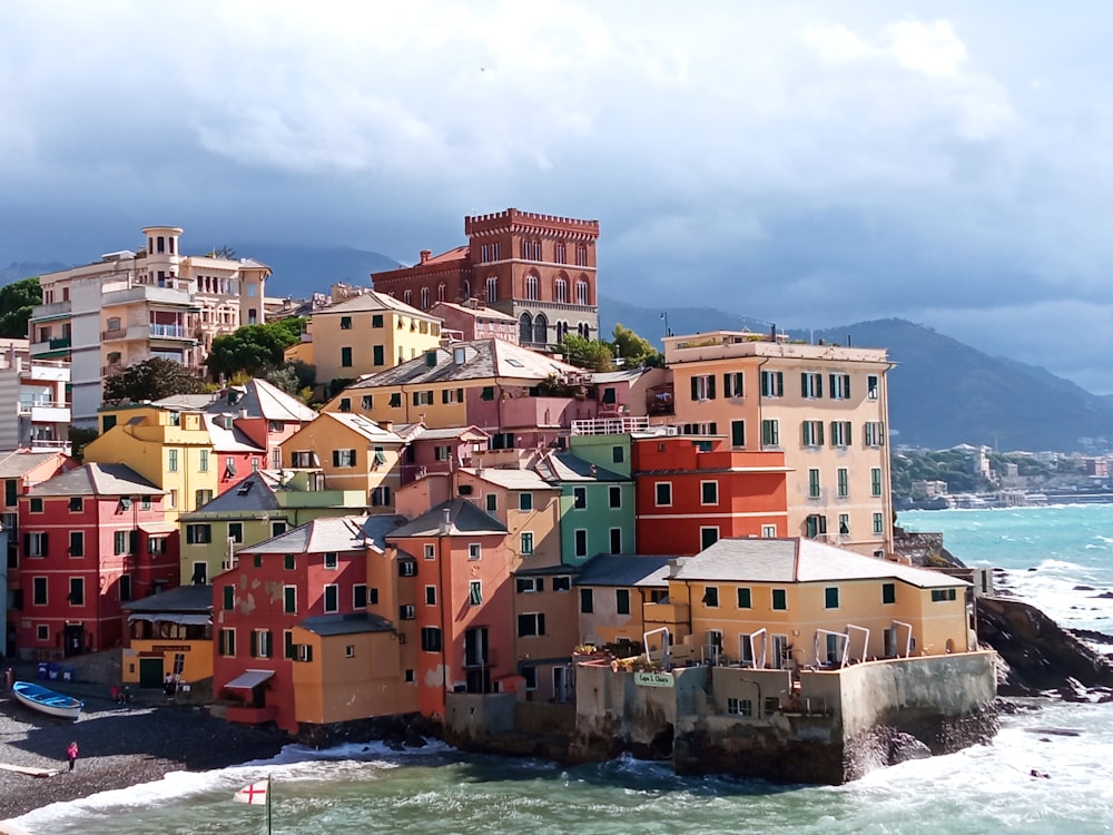 a group of buildings sitting on top of a beach next to the ocean