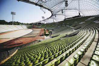 a large empty stadium filled with green seats