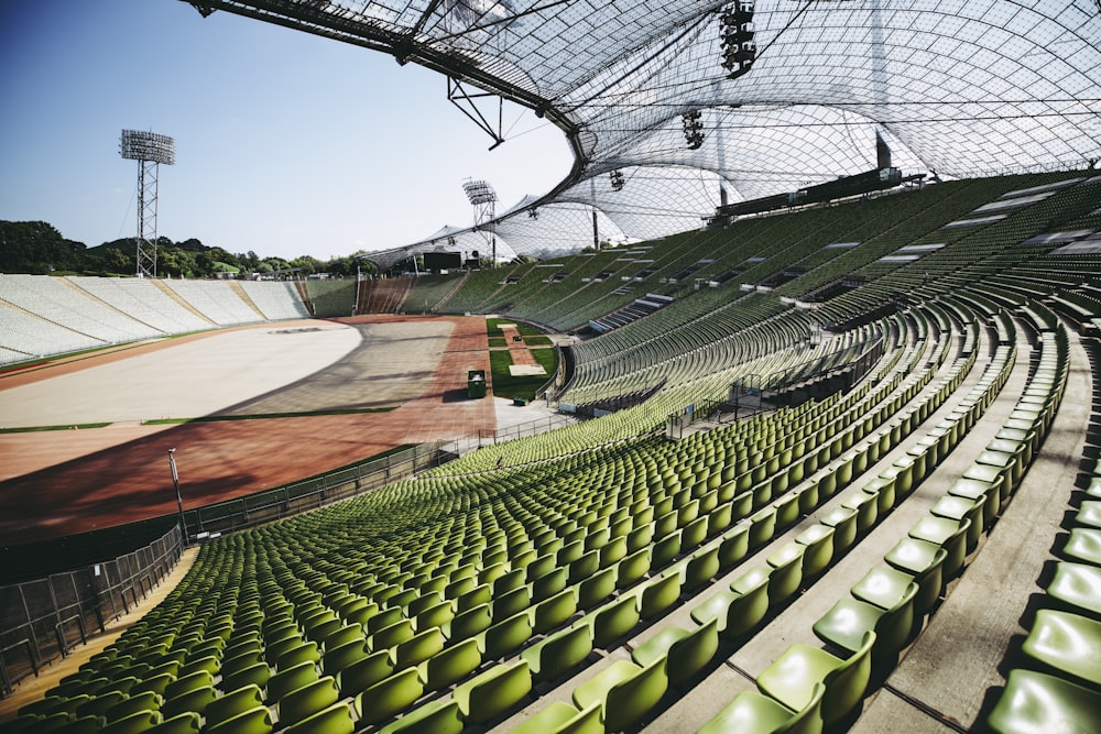 a large empty stadium filled with green seats