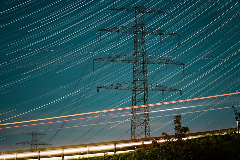 a high voltage power line at night with long exposure