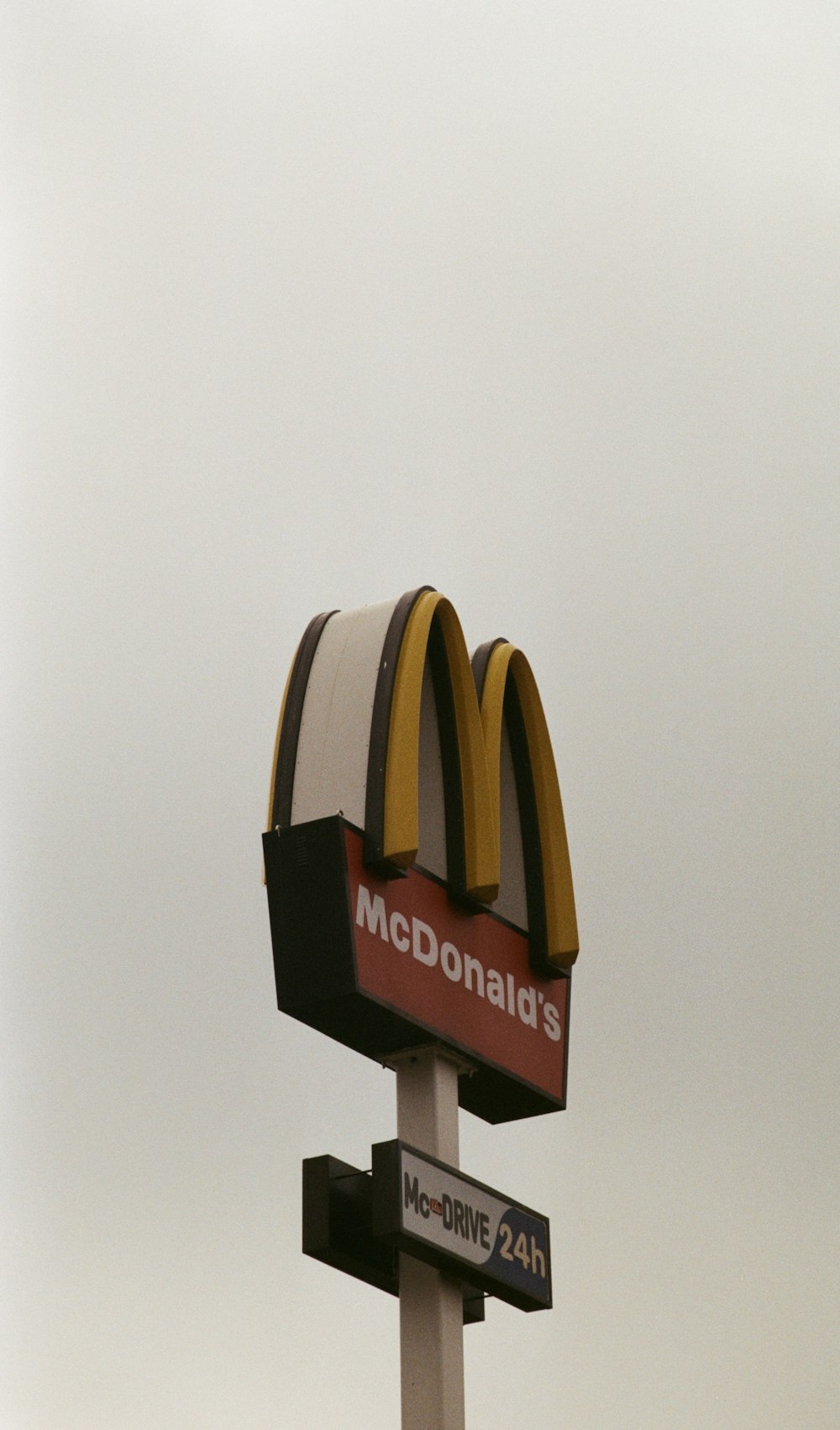 a mcdonald's sign with a sky background