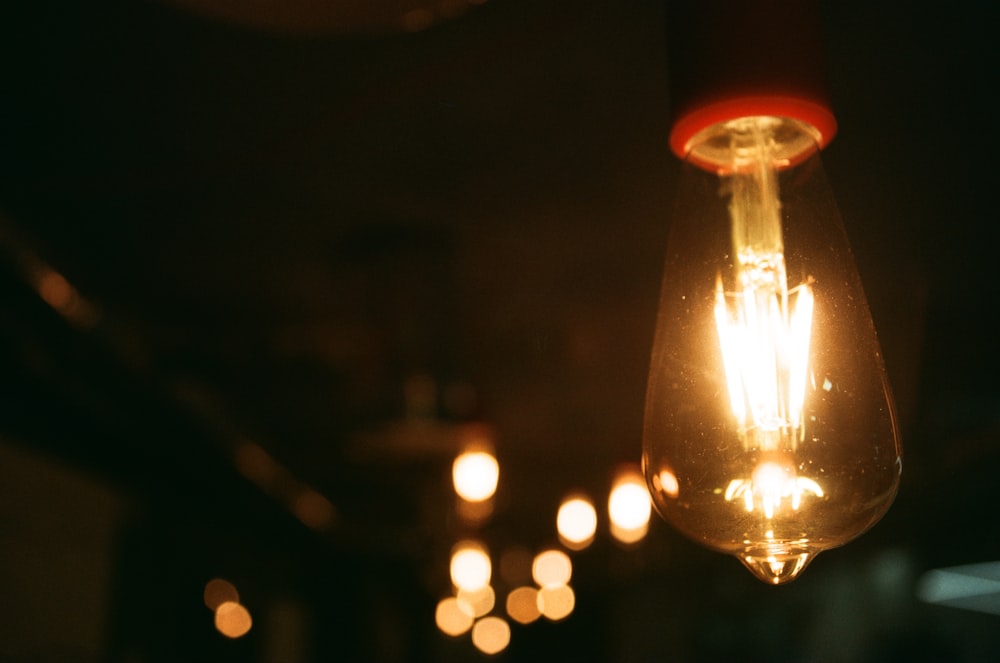 a light bulb hanging from a ceiling in a dark room