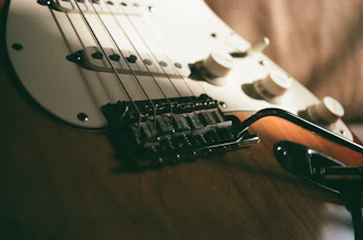 a close up of a guitar and a pair of glasses
