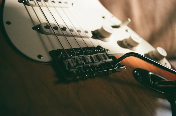 a close up of a guitar and a pair of glasses