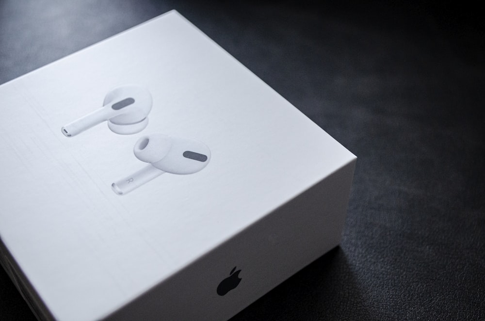 an apple box with two earphones in it