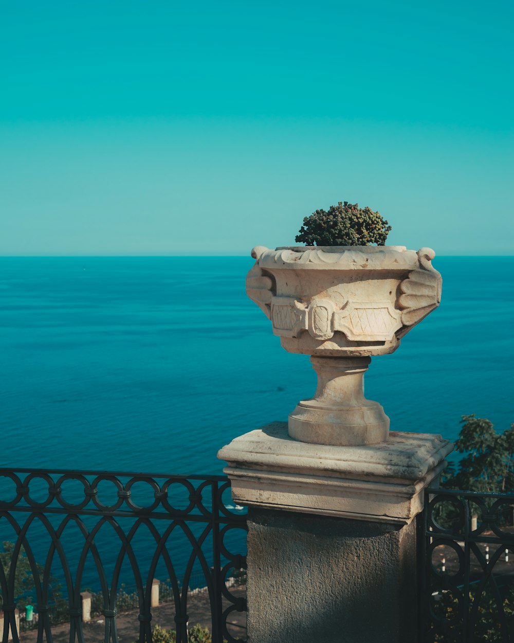 a stone vase with a tree growing out of it