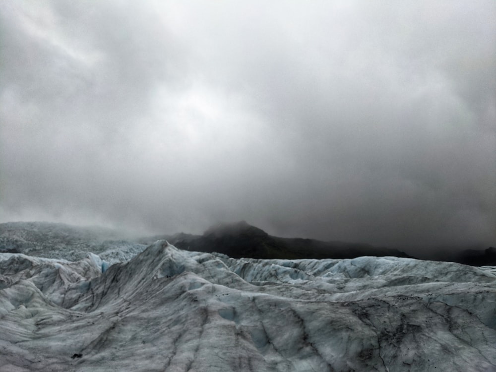 a large glacier with a mountain in the background