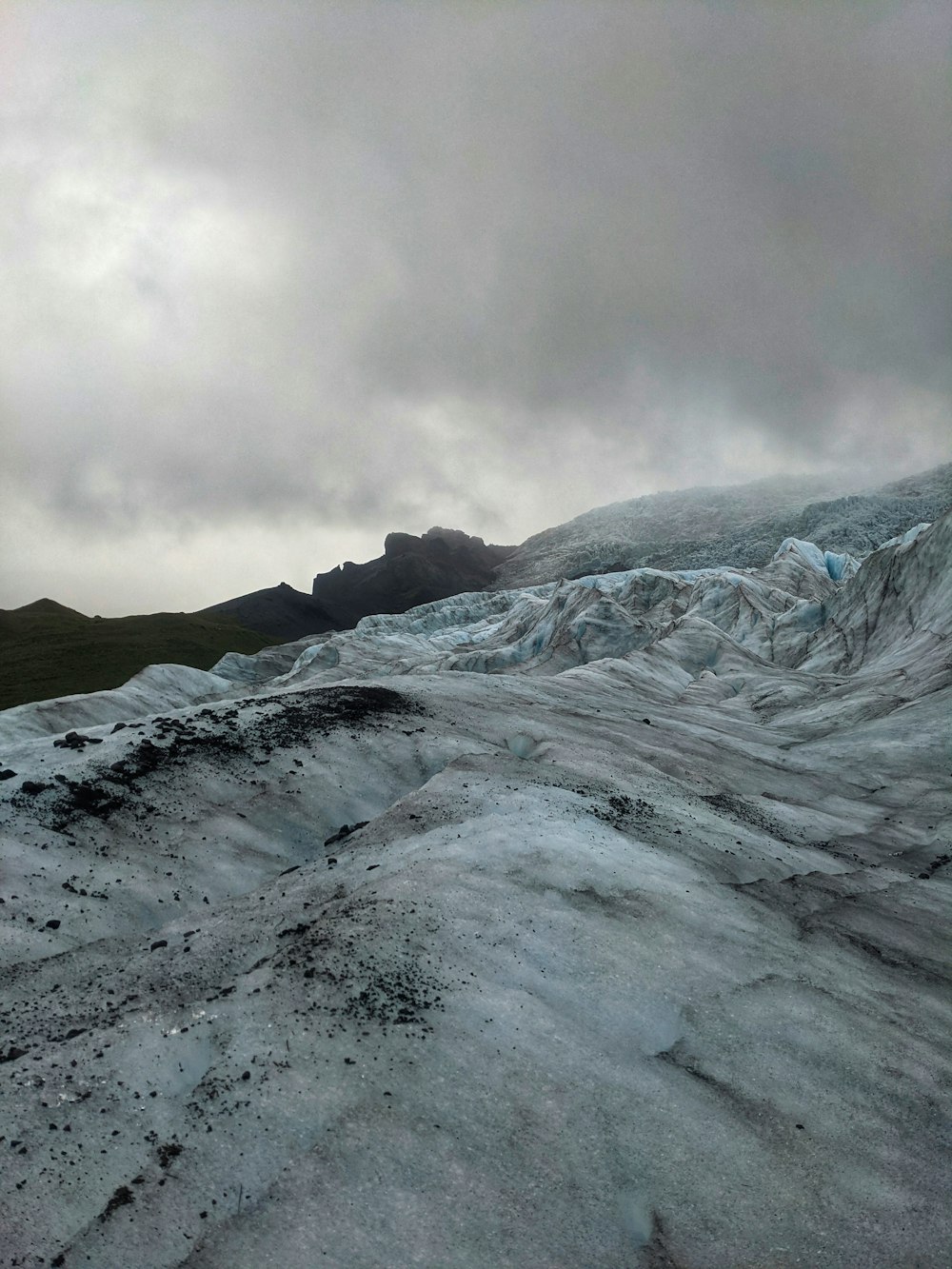 a large glacier with a mountain in the background